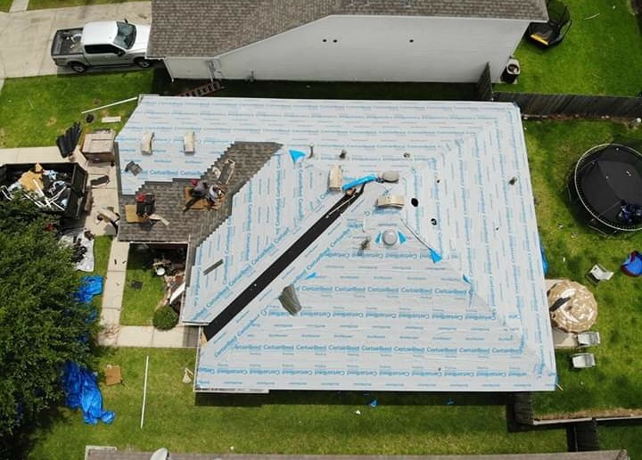 Aerial view of a roof tear-off with CertainTeed synthetic underlayment installed, League City, TX